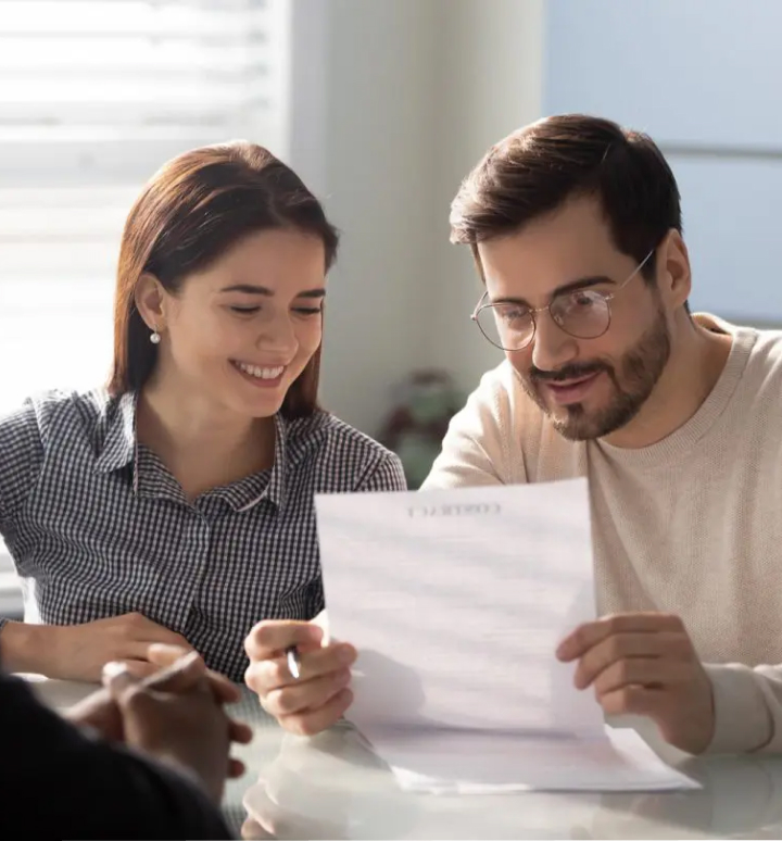 Two people looking at a piece of paper with a life insurance policy on it.
